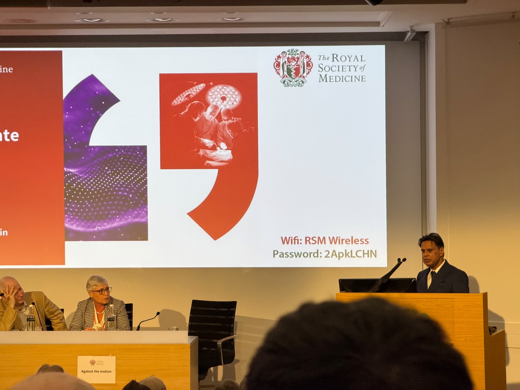 Professor Shafi Ahmed argues against the motion at the RSM. Despite being a self-described futurist, his opposition proved decisive.